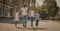 Family Portrait Of Siblings Going Together On Street