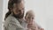 Family portrait smiling caucasian bearded dad father man holding hugging small infant newborn girl boy kid daughter son