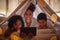 Family portrait, tablet and online app for kids cartoons, streaming and digital night story in blanket fort tent at home
