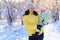 Family portrait in the winter forest, mother and child, bright sunlight and shadows on the snow, beautiful nature