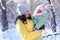 family portrait in the winter forest  mother and child  bright sunlight and shadows on the snow  beautiful nature