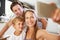 Family Posing For Selfie At Breakfast Table