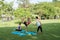 Family practicing yoga in the park outdoor. Concept of healthy l