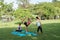 Family practicing yoga in the park outdoor. Concept of healthy l