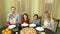 Family praying at dinner table.