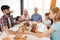 Family praying before dinner for Thanksgiving