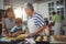 Family preparing dessert in kitchen