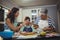 Family preparing dessert in kitchen