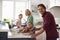 Family Preparing Roast Turkey Meal In Kitchen Together