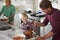 Family Preparing Roast Turkey Meal In Kitchen Together