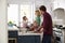 Family Preparing Roast Turkey Meal In Kitchen Together