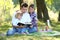 Family read the Bible in nature