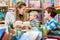 Family reading books in the library