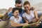 Family reading storybook at home in the living room