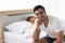 Family relation concept. Young attractive and smiling man relax on bed in the morning. The woman lying on bed cover with white