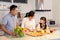 Family relationship, Asian happy family making food preparation in kitchen room at house. Father mother and children having fun sp