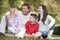 Family relaxing in autumn woodlands