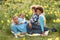 Family Relaxing In Field Of Spring Daffodils