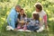 Family Relaxing In Field Of Spring Daffodils