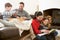 Family Relaxing Indoors Playing Chess And Reading Book