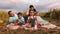 Family resting on picnic in meadow in slow motion