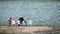 family resting on the shores of the lake