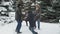 Family rests in winter forest, beautiful landscape with snowy fir trees