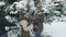 Family rests in winter forest, beautiful landscape with snowy fir trees