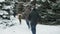 Family rests in winter forest, beautiful landscape with snowy fir trees