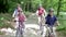 Family Riding Mountain Bikes Along Track