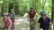 Family Riding Mountain Bikes Along Track