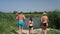 Family running and jumping into the river, summer country holidays