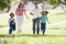 Family running outdoors smiling