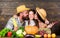 Family rustic style farmers at market with vegetables fruits and greenery. Parents and daughter harvest festival. Family