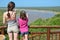 Family safari vacation in South Africa, mother and daughter looking at beautiful african river view, tourists travel Kruger park