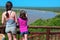 Family safari vacation in South Africa, mother and daughter looking at river view, tourists travel Kruger national park