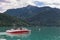 Family sailing in speedboat at Wolfgangsee near Sankt Gilgen, Austria