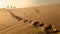 Family on a sand dune with footprints in the sand