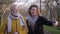 Family selfie, happy granddaughter and grandfather take photo on mobile phone while walking in park