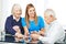 Family with seniors playing cards