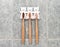 A family set of three bamboo toothbrushes hang on the bathroom`s wall in toothbrush holder. Ecological lifestyle