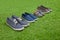 Family shoes standing on green summer grass