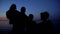 Family silhouette standing against night sea background, unity in difficulties