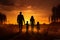 Family silhouette walking in a field at sunset, joyful moment