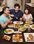 Family sits down to eat together on Thanksgiving