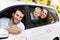 Family sitting in the car looking out windows