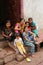 Family sitting on a doorstep in Fatehpur Sikri, Uttar Pradesh, I