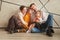 Family sitting on the floor in a new apartment on Christmas eve