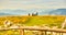 Family sitting on grass and enjoying view over mountains from Schockl in Graz, Austria