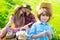 Family sitting on lawn picnic in park. Smiling boy with mother kiss father on an autumns day. Summer together family